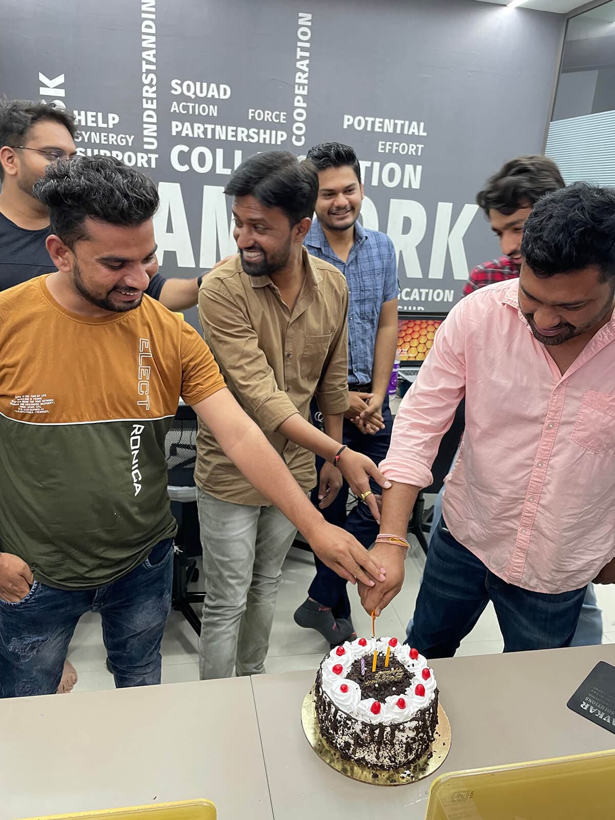 Engross teammates gathered for a cake celebration in the office