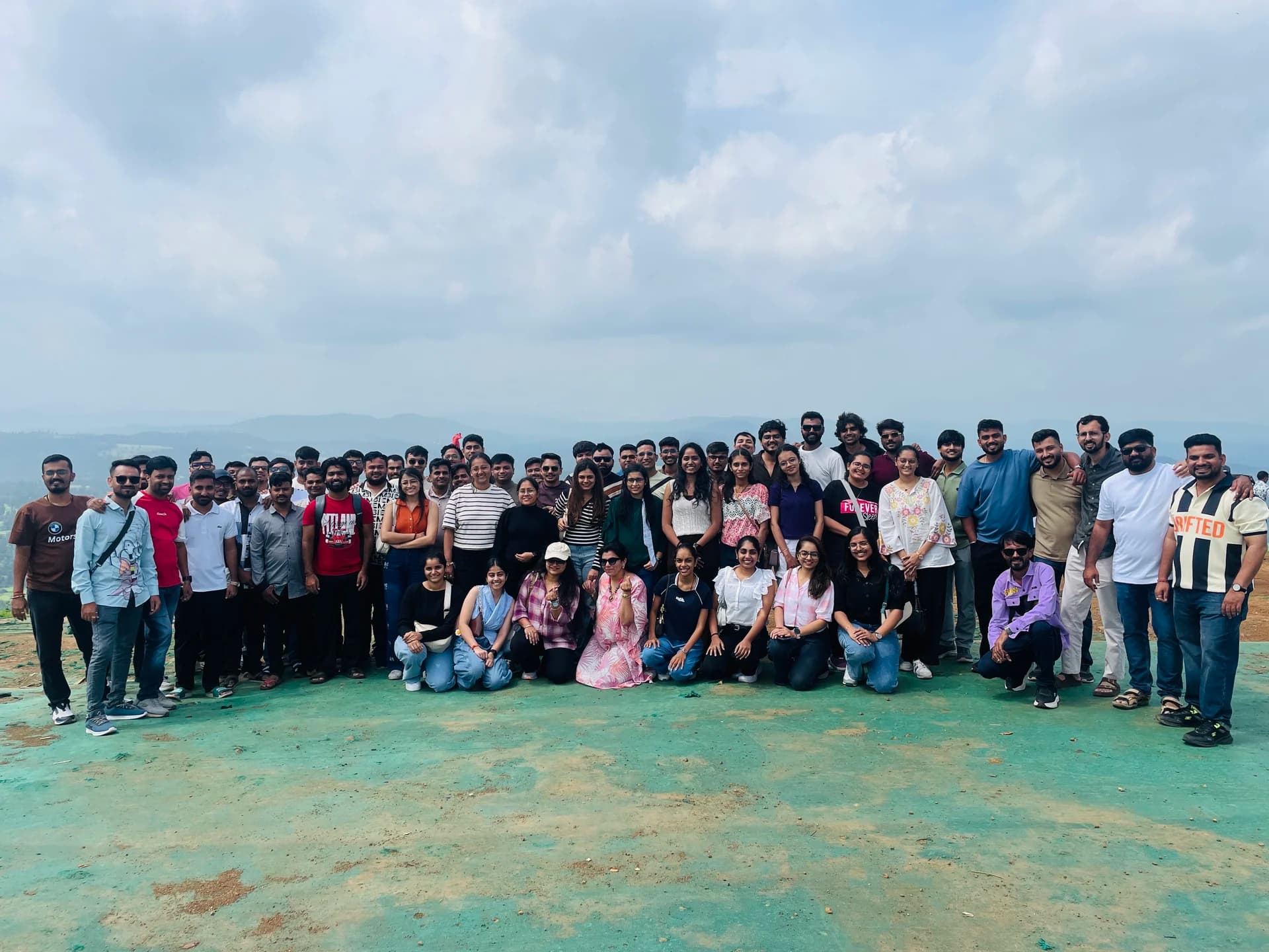 Engross teammates gathered for a group photo on a hilltop outing